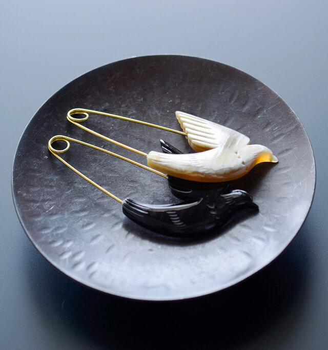 天然素材を使用し作られた
クラシカルな雰囲気漂うブローチ。
艶のある美しい質感は、
微妙な色の重なりを見る事ができ、
とても神秘的です。
ジャケットの胸元や
マフラー留め・帽子などに付けて
コーディネートのアクセントに最適。