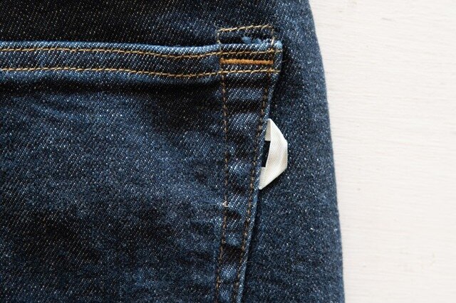 右後ろのポケットの脇側に白のリボンのような紐が縫い付けられてます。
実はこれ、DEEPER’S WEARの頭文字「Ｄ」を表した隠れこだわりポイント。