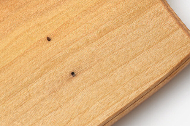 例えば木製品では、写真のような虫食い跡（人工乾燥をしているため虫はいません）や、木目の節の色が悪いもの、使用上問題無い程度の僅かな割れや欠けが。